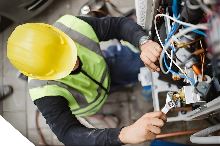 Technician performing maintenance on industrial machinery or energy system components.