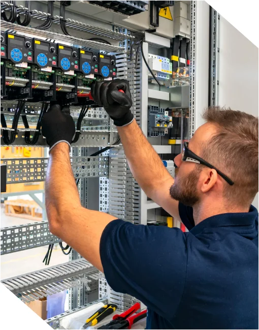 Precision engineering for industrial electrical control and automation. Engineer performing wiring in an industrial control panel for electrical control systems.